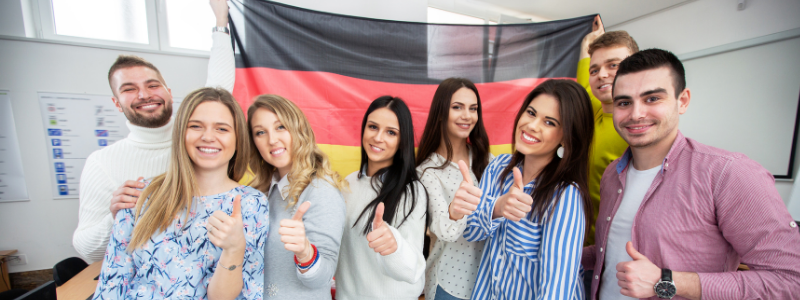 A Group Standing in Front of a German Flag