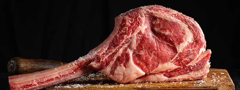 salted steak on a wooden board