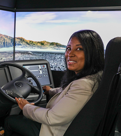 Female using a truck driving simulator