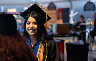 Female Student in a Graduation Cap and Gown