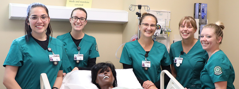 Women Nurses Around a Patient's Bed